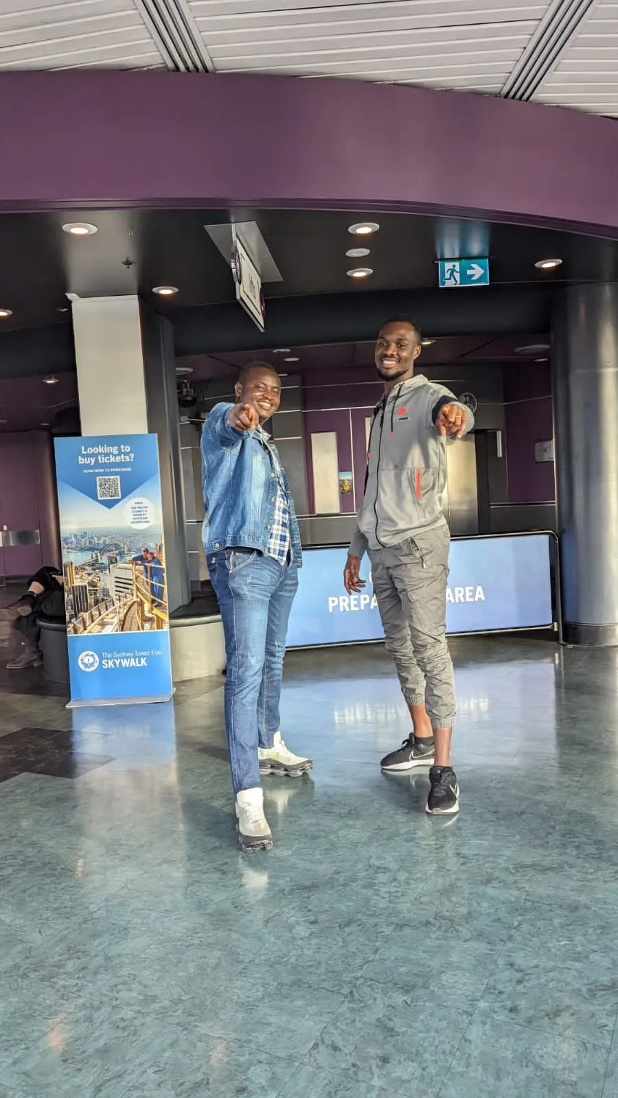 Kenneth and a friend posing in a lobby
