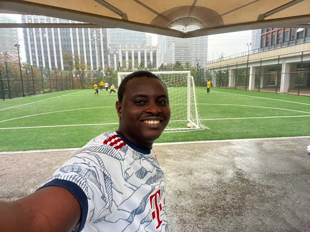 Kenneth taking a selfie on a football pitch